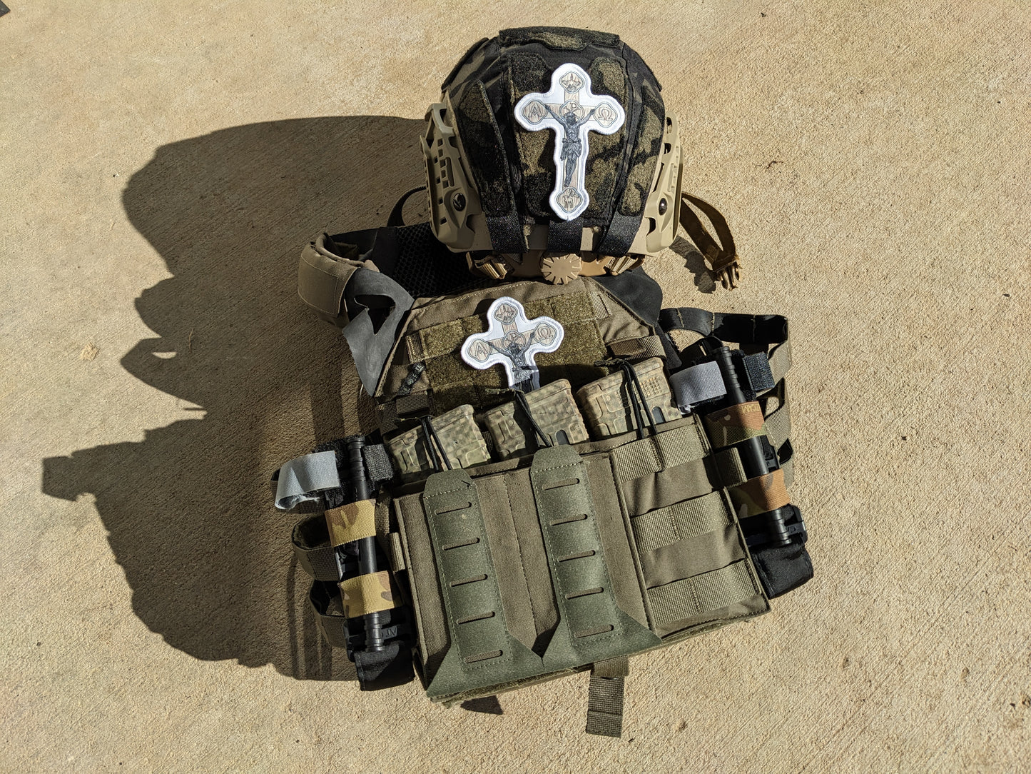 Plate carrier and helmet with white crucifix patch